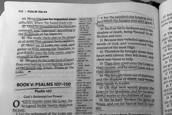 Psalm 107 in an open Bible, verse 9 boxed in pen